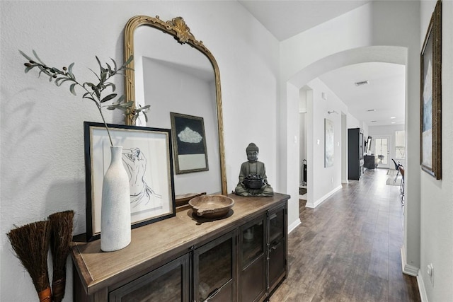 200 Isabella Way, Liberty Hill, TX 78642 - hall featuring arched walkways, dark wood-style floors, and baseboards