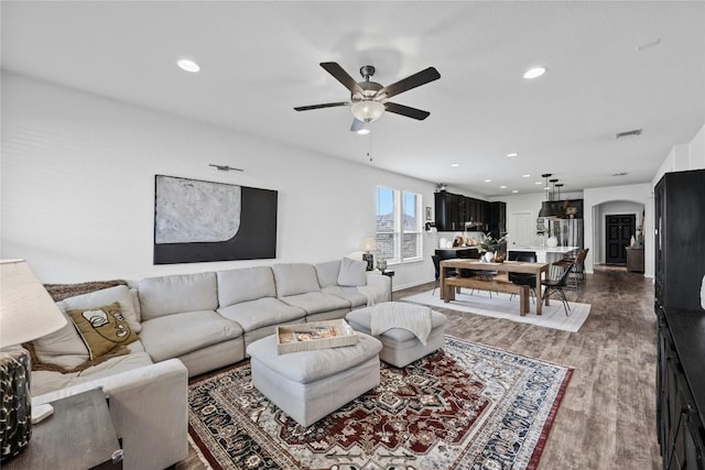 200 Isabella Way, Liberty Hill, TX 78642 - living room with ceiling fan, arched walkways, wood finished floors, recessed lighting, and baseboards