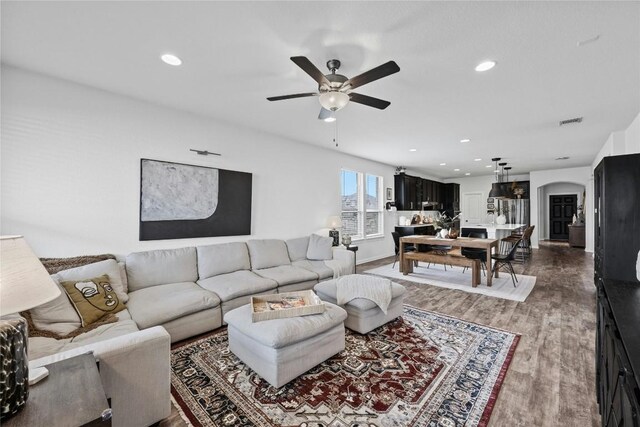 200 Isabella Way, Liberty Hill, TX 78642 - living area featuring a ceiling fan, arched walkways, wood finished floors, and recessed lighting