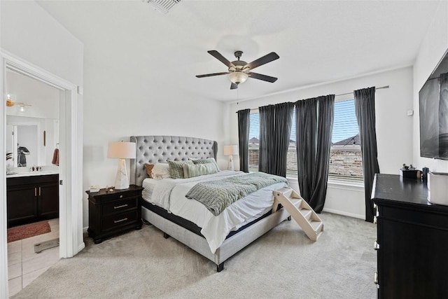 200 Isabella Way, Liberty Hill, TX 78642 - bedroom with a ceiling fan, connected bathroom, light colored carpet, and a sink