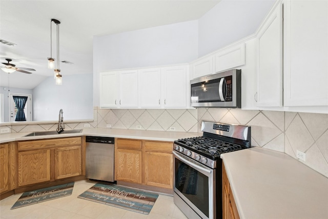 1006 Mapleridge Cir, Leander, TX 78641 - kitchen with appliances with stainless steel finishes, a sink, ceiling fan, backsplash, and light countertops