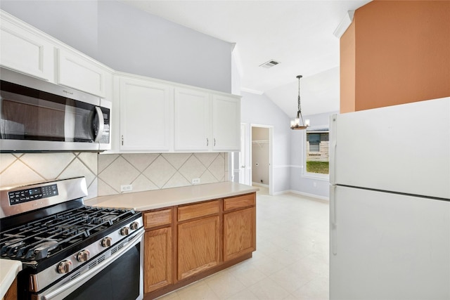 1006 Mapleridge Cir, Leander, TX 78641 - kitchen with appliances with stainless steel finishes, vaulted ceiling, backsplash, a chandelier, and light countertops