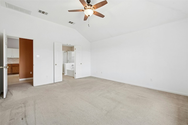 1006 Mapleridge Cir, Leander, TX 78641 - unfurnished bedroom featuring lofted ceiling, light colored carpet, ensuite bath, baseboards, and a ceiling fan