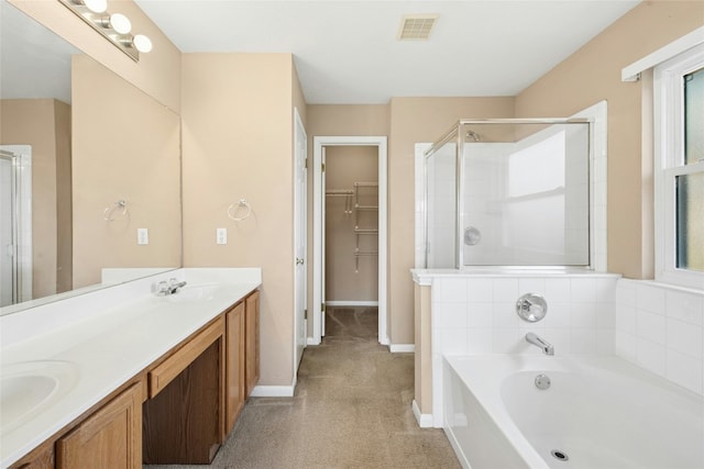 1006 Mapleridge Cir, Leander, TX 78641 - full bath with a shower stall, double vanity, a bath, a spacious closet, and baseboards