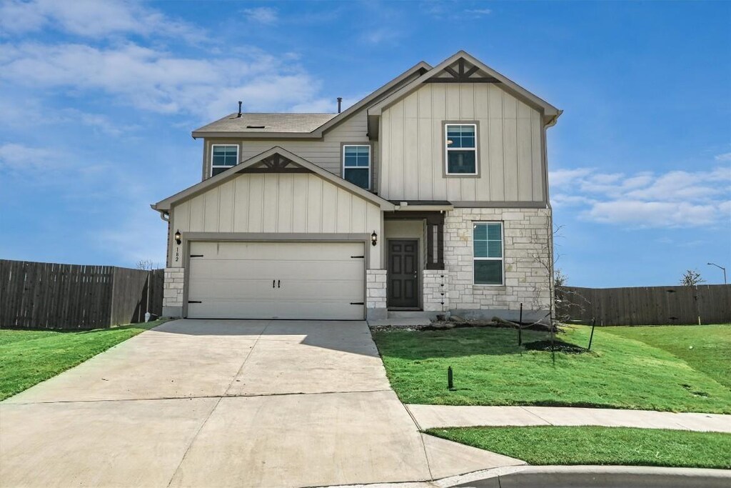 182 Bayberry Cir, Buda, TX 78610 - craftsman-style home featuring stone siding, fence, a front yard, board and batten siding, and driveway