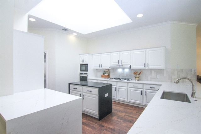 kitchen with ornamental molding, stainless steel oven, gas cooktop, under cabinet range hood, and a sink