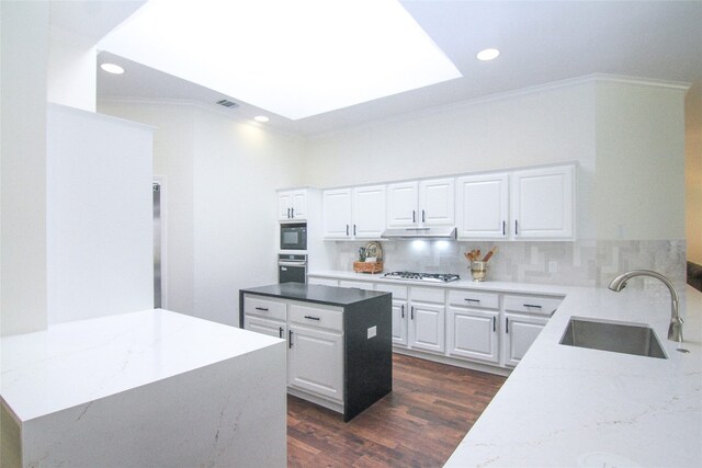 8102 Davis Mountain Pass, Austin, TX 78726 - kitchen with crown molding, oven, under cabinet range hood, white gas stovetop, and dark wood finished floors