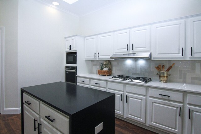 8102 Davis Mountain Pass, Austin, TX 78726 - kitchen featuring appliances with stainless steel finishes, under cabinet range hood, ornamental molding, backsplash, and dark wood-style flooring
