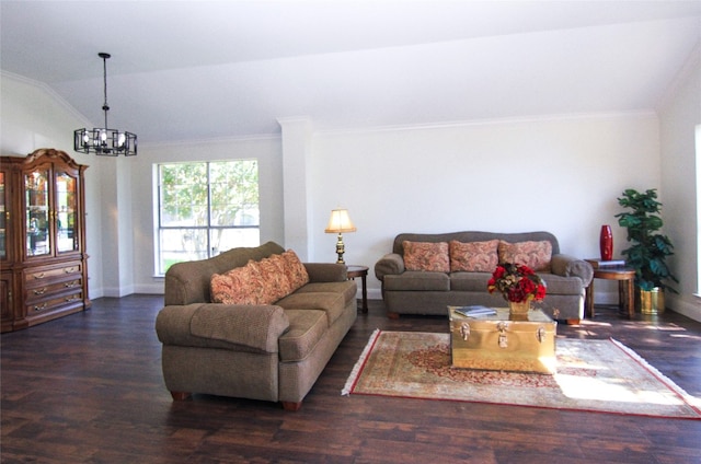 living area with an inviting chandelier, baseboards, wood finished floors, vaulted ceiling, and ornamental molding