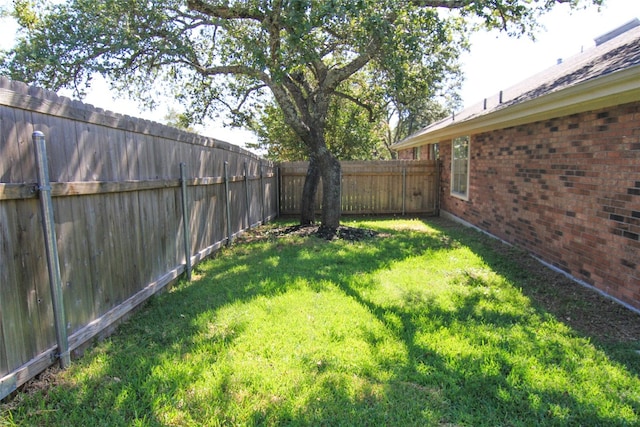 view of yard with a fenced backyard