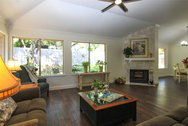 living room with a tiled fireplace, ceiling fan with notable chandelier, wood finished floors, and lofted ceiling