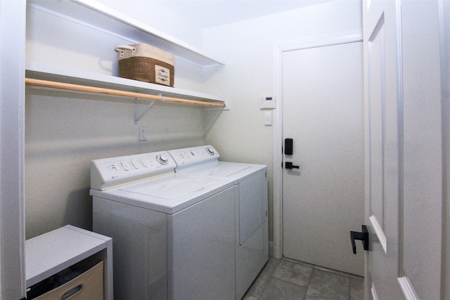 laundry area with light tile patterned floors, laundry area, and washer and clothes dryer