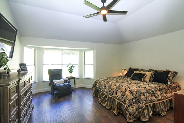 bedroom featuring baseboards, dark wood-style flooring, ceiling fan, and vaulted ceiling