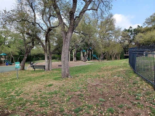 view of yard featuring fence and playground community