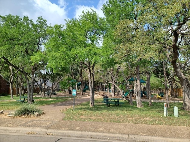view of property's community with a yard and playground community