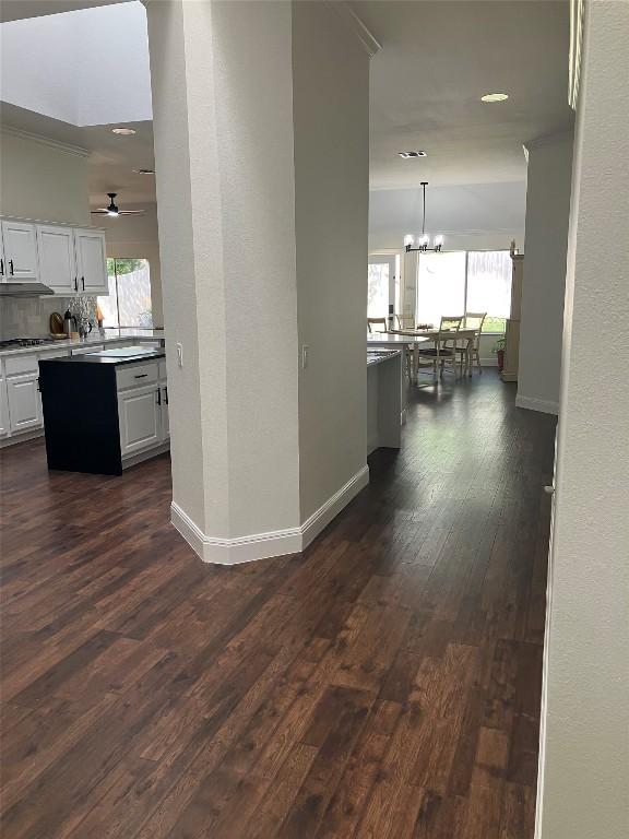 8102 Davis Mountain Pass, Austin, TX 78726 - hallway with a chandelier, dark wood-style floors, ornamental molding, and recessed lighting