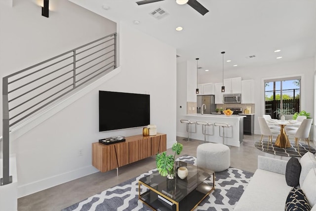900 Banister Ln Unit D, Austin, TX 78704 - living room with a ceiling fan, finished concrete flooring, and recessed lighting