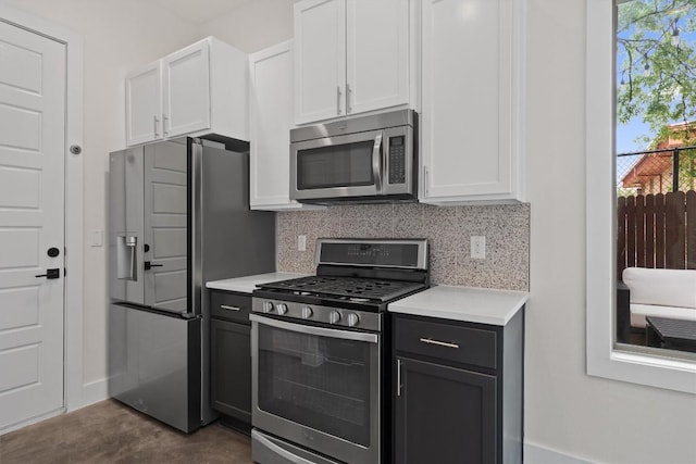 900 Banister Ln Unit D, Austin, TX 78704 - kitchen with appliances with stainless steel finishes, light countertops, white cabinetry, and tasteful backsplash