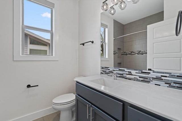 900 Banister Ln Unit D, Austin, TX 78704 - bathroom featuring decorative backsplash, a tile shower, and vanity