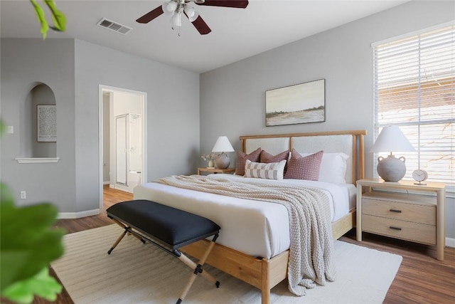 3100 Lynnbrook Dr, Austin, TX 78748 - bedroom with wood finished floors, baseboards, ensuite bath, and a ceiling fan