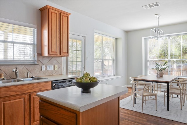 3100 Lynnbrook Dr, Austin, TX 78748 - kitchen with a sink, black dishwasher, light countertops, and brown cabinets