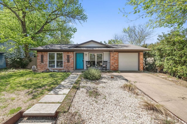 5304 Harvest Ln, Austin, TX 78745 - view of front facade with brick siding, an attached garage, driveway, a front yard, and a porch