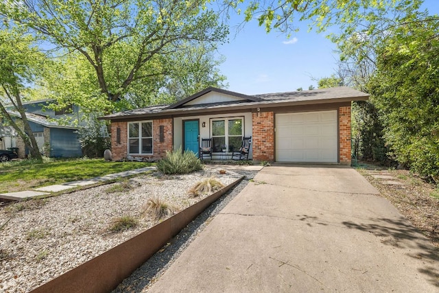 view of front facade featuring driveway, an attached garage, and brick siding