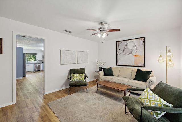 5304 Harvest Ln, Austin, TX 78745 - living room featuring wood finished floors, ceiling fan, and baseboards
