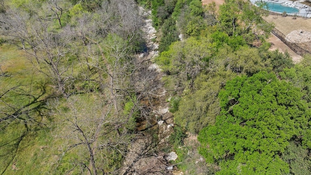 birds eye view of property featuring a wooded view