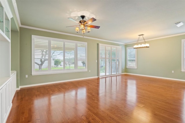 111 Belfalls Dr, Georgetown, TX 78633 - spare room featuring ceiling fan, wood finished floors, baseboards, crown molding, and a chandelier