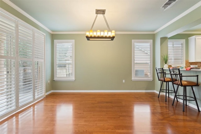 111 Belfalls Dr, Georgetown, TX 78633 - dining area with wood finished floors, ornamental molding, and baseboards