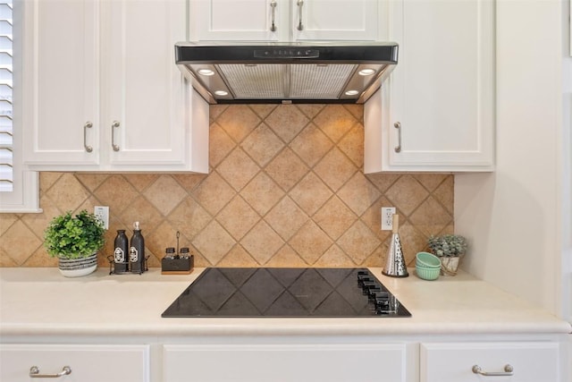 111 Belfalls Dr, Georgetown, TX 78633 - kitchen with under cabinet range hood, black electric stovetop, white cabinets, and light countertops