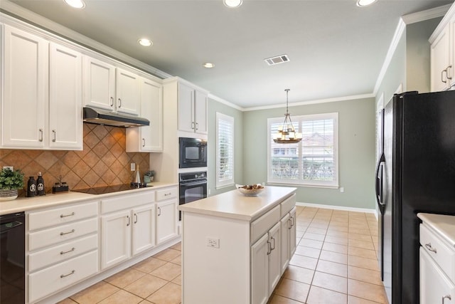 111 Belfalls Dr, Georgetown, TX 78633 - kitchen with under cabinet range hood, black appliances, ornamental molding, tasteful backsplash, and light tile patterned floors