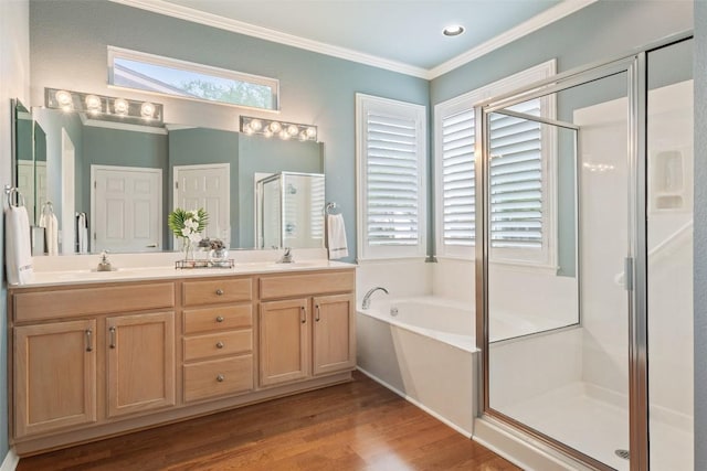 111 Belfalls Dr, Georgetown, TX 78633 - full bath with a shower stall, double vanity, crown molding, a bath, and wood finished floors