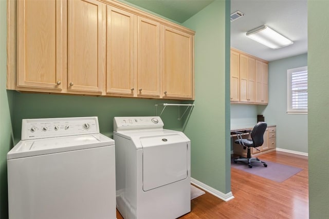 111 Belfalls Dr, Georgetown, TX 78633 - washroom featuring cabinet space, washing machine and clothes dryer, light wood-style floors, baseboards, and a desk