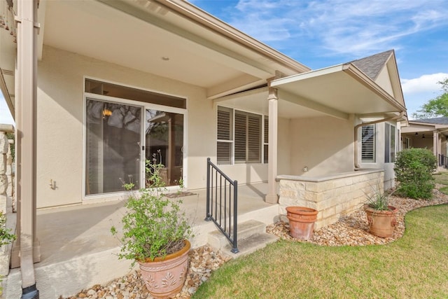 111 Belfalls Dr, Georgetown, TX 78633 - view of exterior entry featuring stucco siding and a yard