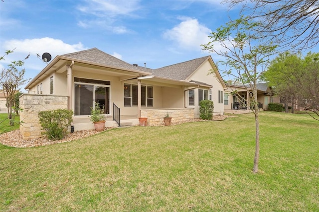 111 Belfalls Dr, Georgetown, TX 78633 - rear view of house with stucco siding, a lawn, stone siding, and a shingled roof