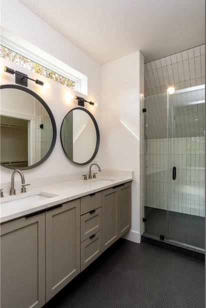 504 Normandy St Unit A, Austin, TX 78745 - bathroom featuring double vanity and a shower stall