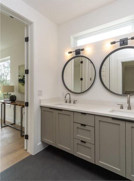 504 Normandy St Unit A, Austin, TX 78745 - full bathroom featuring double vanity, plenty of natural light, and wood finished floors
