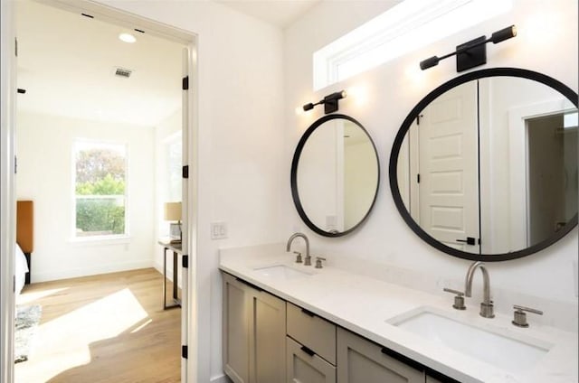 504 Normandy St Unit A, Austin, TX 78745 - full bathroom with wood finished floors, double vanity, and baseboards