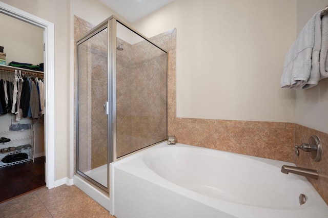 7901 SW Pkwy Unit 21, Austin, TX 78735 - full bath with a bath, a walk in closet, a shower stall, and tile patterned floors