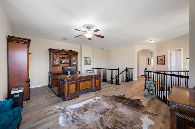 7901 SW Pkwy Unit 21, Austin, TX 78735 - office area featuring ceiling fan, wood finished floors, arched walkways, and baseboards