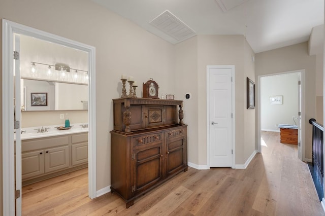 7901 SW Pkwy Unit 21, Austin, TX 78735 - corridor featuring light wood-style flooring, attic access, and baseboards