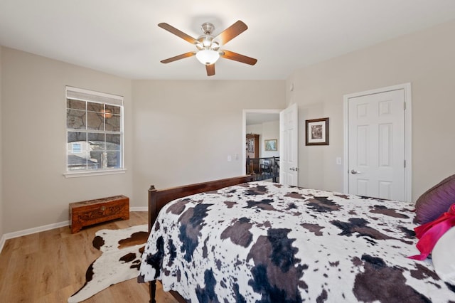 7901 SW Pkwy Unit 21, Austin, TX 78735 - bedroom featuring wood finished floors, ceiling fan, and baseboards