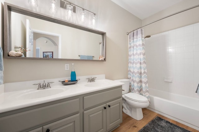 7901 SW Pkwy Unit 21, Austin, TX 78735 - full bathroom with toilet, double vanity, shower / tub combo with curtain, and wood finished floors