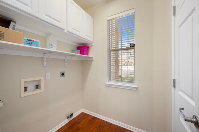 7901 SW Pkwy Unit 21, Austin, TX 78735 - washroom featuring hookup for a washing machine, electric dryer hookup, baseboards, dark wood finished floors, and cabinet space