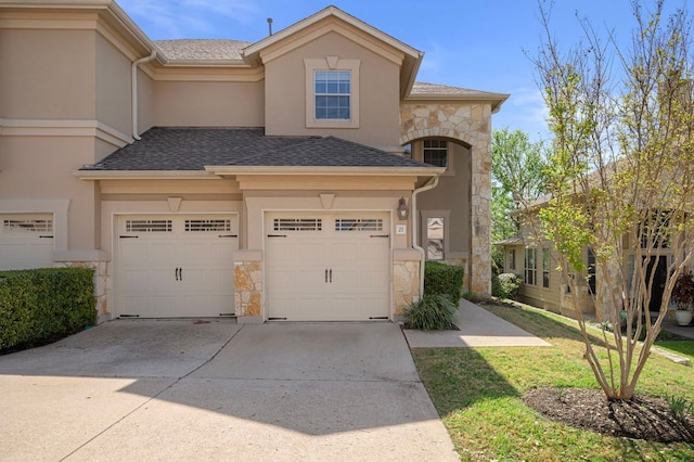 7901 SW Pkwy Unit 21, Austin, TX 78735 - view of front of house with stone siding, concrete driveway, a garage, and stucco siding
