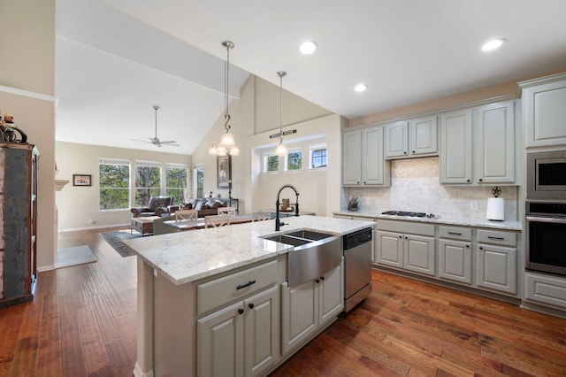 7901 SW Pkwy Unit 21, Austin, TX 78735 - kitchen with appliances with stainless steel finishes, gray cabinets, a sink, open floor plan, and tasteful backsplash