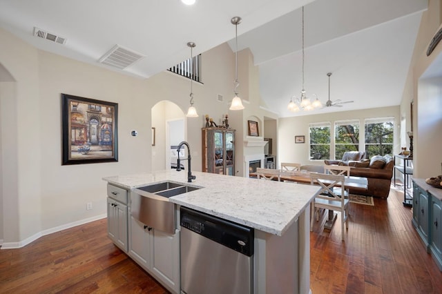 7901 SW Pkwy Unit 21, Austin, TX 78735 - kitchen with dishwasher, arched walkways, a sink, a fireplace, and open floor plan