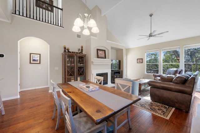 7901 SW Pkwy Unit 21, Austin, TX 78735 - dining area featuring arched walkways, high vaulted ceiling, a fireplace, ceiling fan, and wood-type flooring